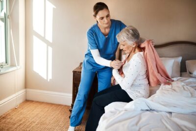 shot-of-a-young-nurse-helping-a-senior-woman-get-small